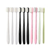 A set of ten ultra-fine bristle toothbrushes in various pastel colors, including white, pink, and green.