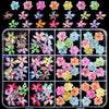 A collection of colorful floral resin nail charms featuring hibiscus flowers in various shades and patterns.