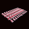 A set of 120 pink French ballet press-on nails arranged in a linear fashion.