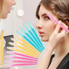 A woman holds a multi-use stainless steel razor set with various colored blades, including pink and yellow, near her face.