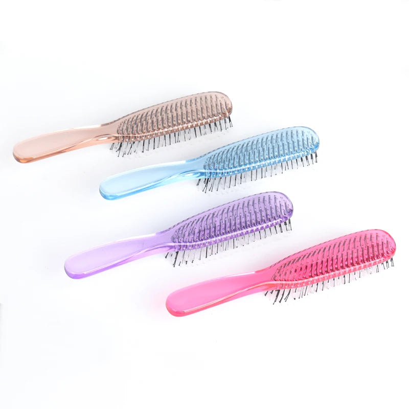 A collection of four plastic scalp massage combs in various shades including pink, blue, purple, and clear.