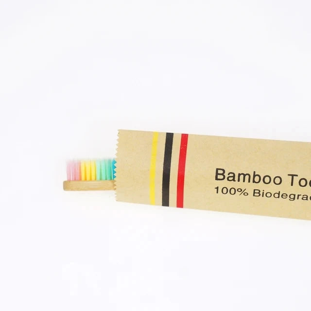 A package of bamboo toothbrushes with colorful bristles and branding text.