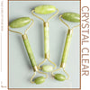 A set of three jade gua sha facial massagers in light green color displayed on a neutral background.