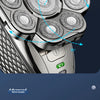 Close-up view of a silver electric head shaver with multiple rotating heads and a full body washable design.