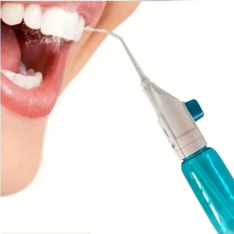 A close-up of a manual high-pressure dental flosser being used to clean teeth.