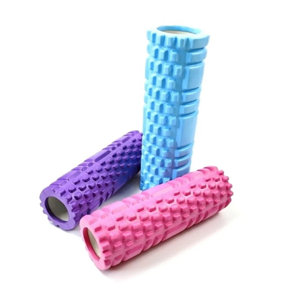 A stack of blue and purple fitness foam rollers for muscle recovery.