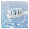 A white sonic electric toothbrush with multiple bristles is shown floating in clear blue water.