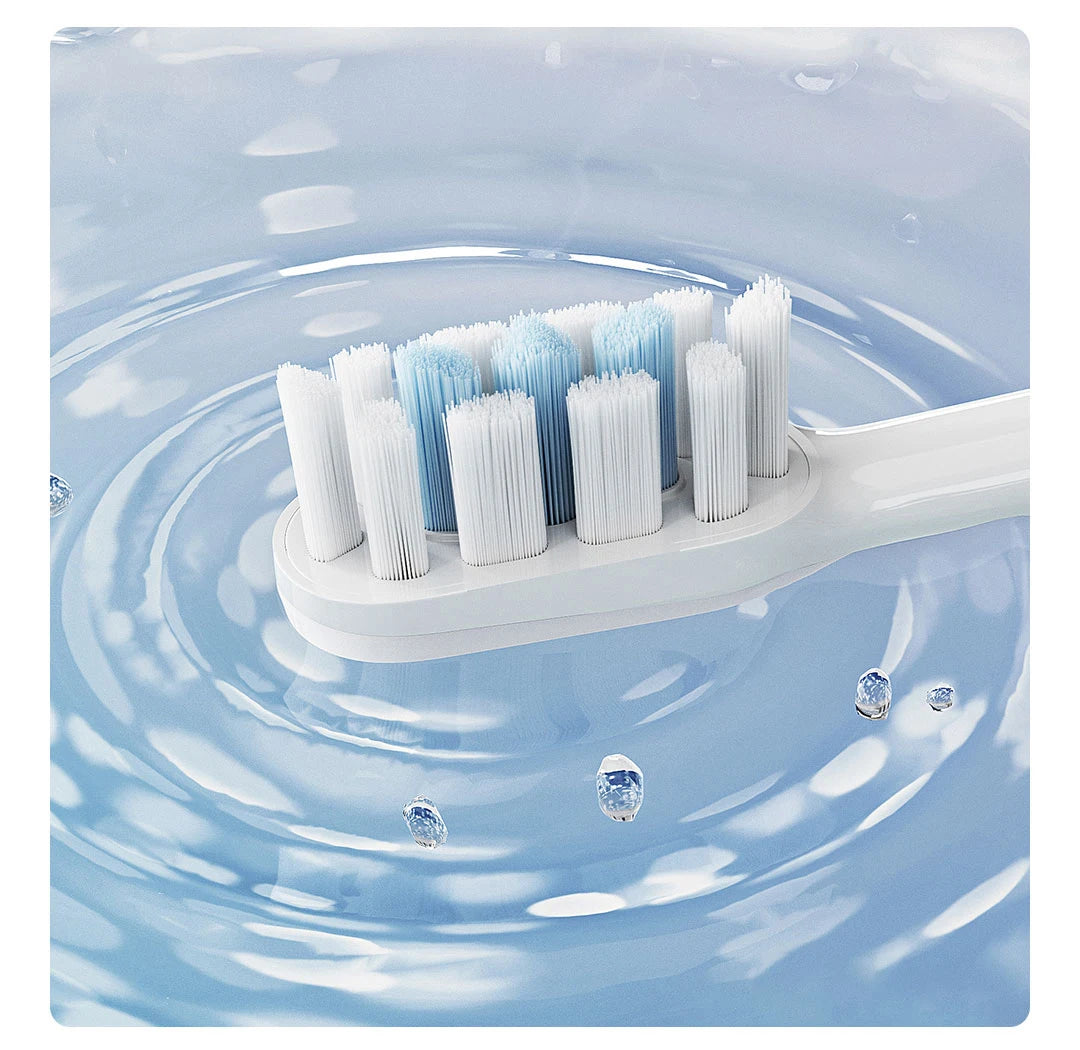 A white sonic electric toothbrush with multiple bristles is shown floating in clear blue water.