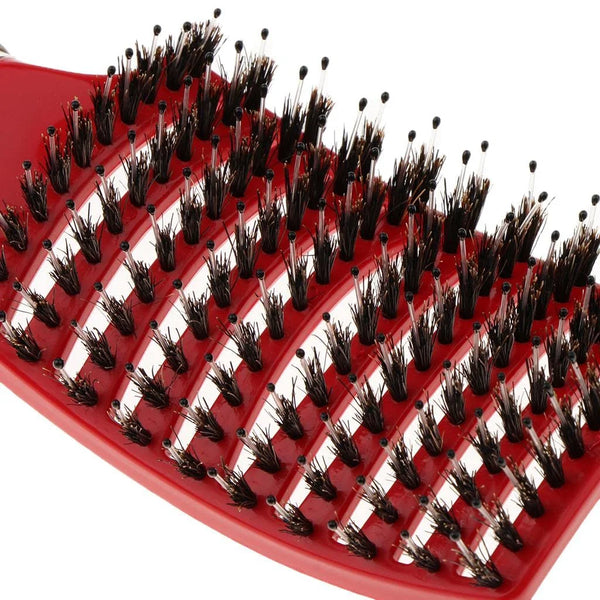 A red nylon bristle detangling comb with numerous bristles for wet hair.