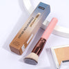 A large foundation brush in a cardboard box and a pink flat angled makeup brush are displayed on a white surface.