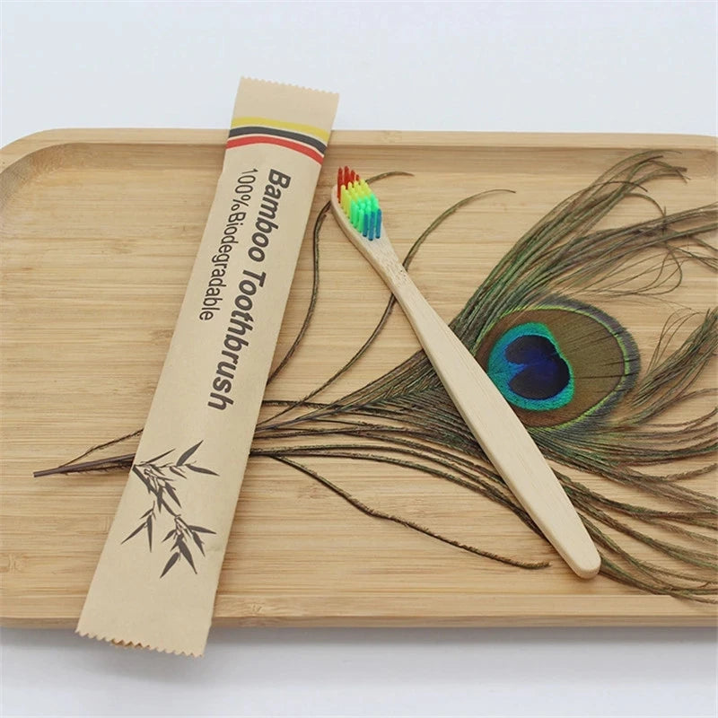 A bamboo toothbrush packaged in a cardboard sleeve rests on a wooden cutting board next to a single toothbrush and loose bamb