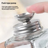 A hand is pressing the pump of a refillable glass nail art dispenser bottle.