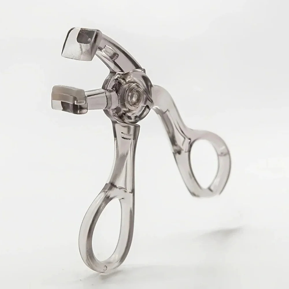 A clear dual-type eyelash curler with a comb is shown against a white background.