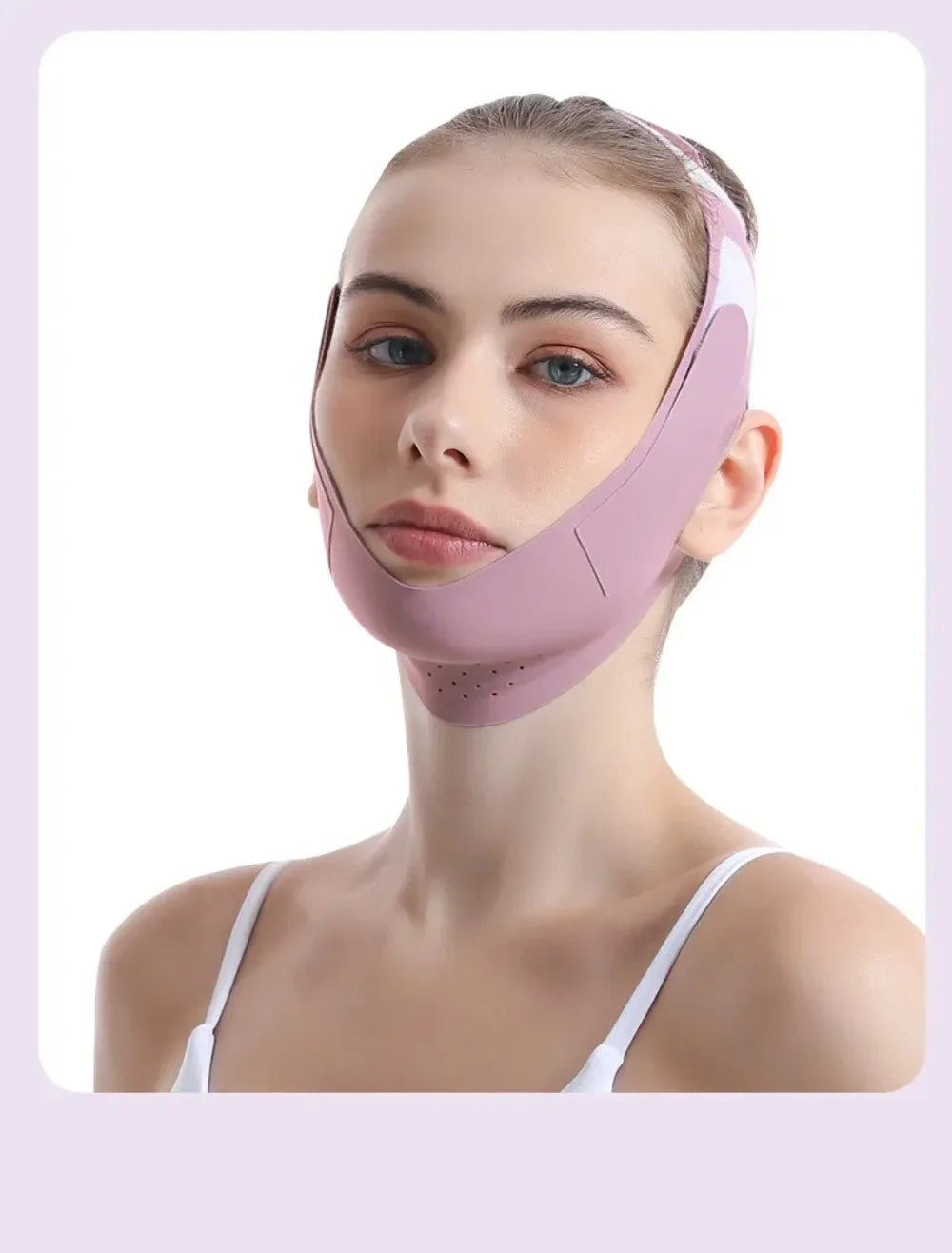 A woman wearing a pink facial lifting strap designed for contour definition.