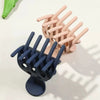 A set of light pink and dark blue root lifting hair clips for volume and bouncy curls