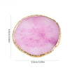 A round, translucent pink quartz crystal with a gold-colored rim.