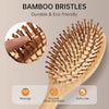 A wooden bamboo bristled comb used for scalp massage and promoting blood circulation to achieve fluffy hair.