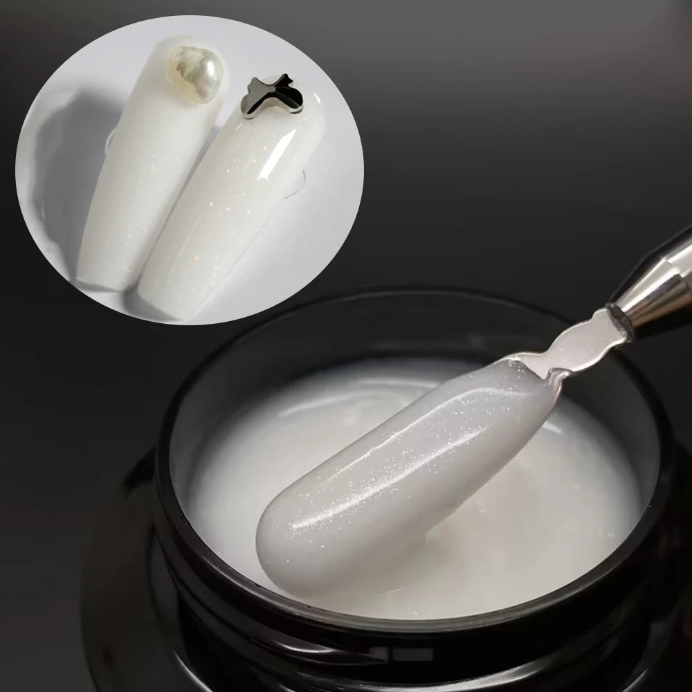 Un constructeur de gel moyen auto-nivelant blanc pour extensions d'ongles, présenté dans un pot avec un applicateur argenté e