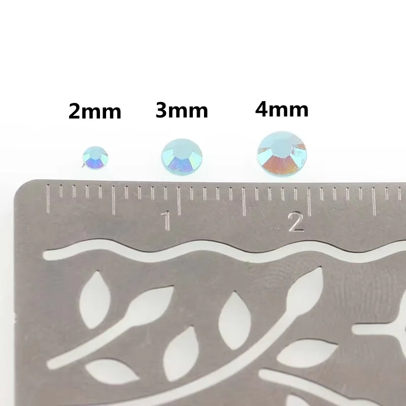 A set of mixed color resin drill bits labeled 2mm, 3mm, and 4mm placed on a ruler.