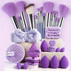A collection of purple beauty sponges and brushes displayed on a white surface.