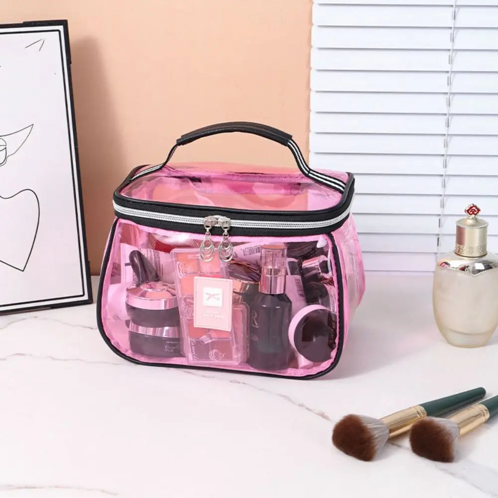 A pink clear cosmetic bag with a black handle is shown open, containing various makeup bottles and tools.