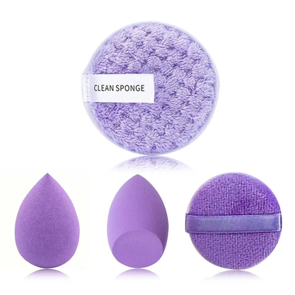 A purple clean sponge and three purple makeup brushes are displayed on a white background.