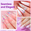 Close-up of elegant pink and white acrylic nails decorated with sparkling rhinestones and glitter.