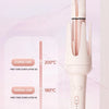 A pink automatic rotating ceramic hair curling iron with a temperature control display and a hair texture guide.