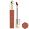 A tube of liquid bronzer contour foundation stick with a metallic cap and a brush applicator, shown next to a round product p