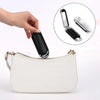 White faux leather folding mini hair comb with mirror shown next to a small white purse.