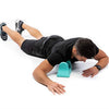 A person is using a teal psoas muscle massager for deep tissue release on their leg.