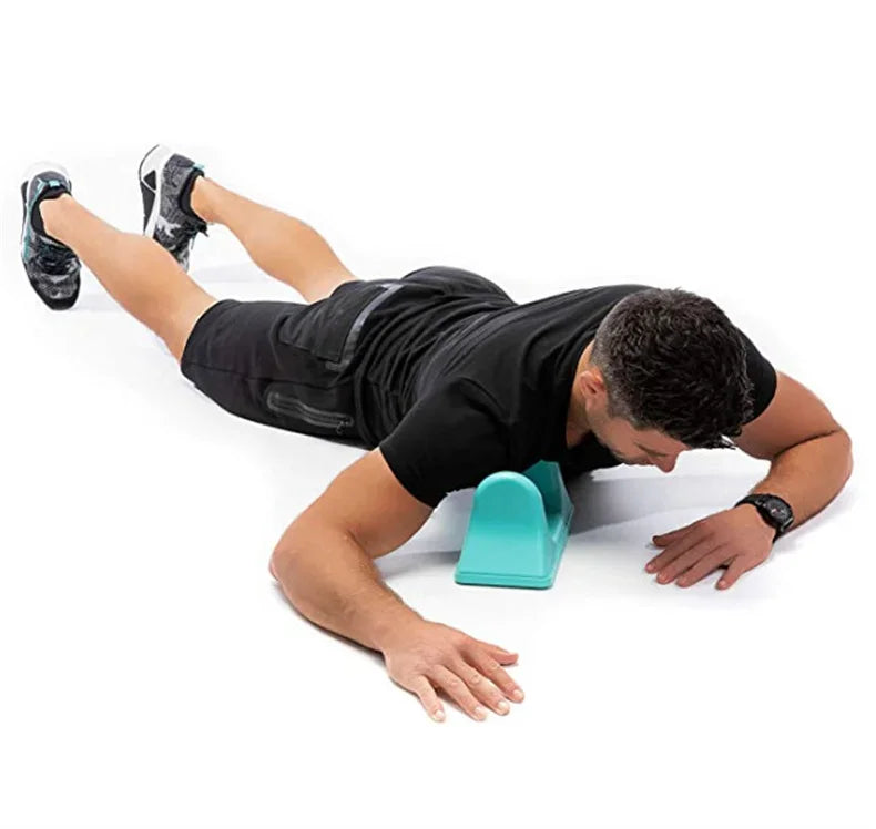 A person is using a teal psoas muscle massager for deep tissue release on their leg.