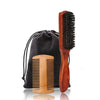 A wooden boar bristle beard brush and comb set with a black fabric gift bag.