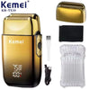 A gold and black electric foil shaver with accessories including a shaver head and replacement foils.
