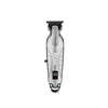 A silver professional cordless hair trimmer with a guard and battery indicator light.