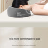 A gray ergonomic memory foam cervical spine angle pillow is positioned on a person's neck for relaxation.