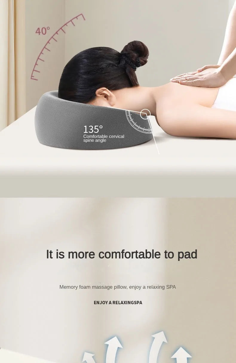 A gray ergonomic memory foam cervical spine angle pillow is positioned on a person's neck for relaxation.