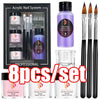 Professional acrylic nail system set including powder, liquid monomer, and brushes in a black box.