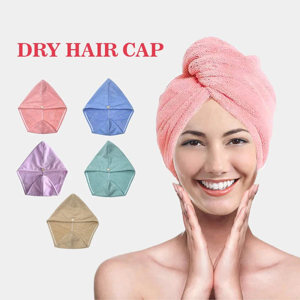A woman is smiling while wearing a pink dry hair cap, with various colored caps displayed nearby.