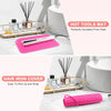 A pink silicone heat resistant mat is shown next to a hair iron cover and various glass bottles on a gold tray.