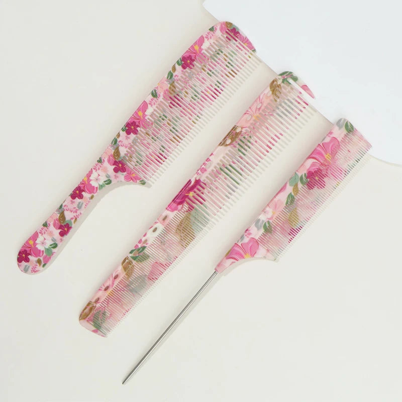 A set of three pink floral-patterned hair combs for styling.
