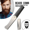 A close-up of a black and silver foldable anti-static steel comb used for managing beard hair.