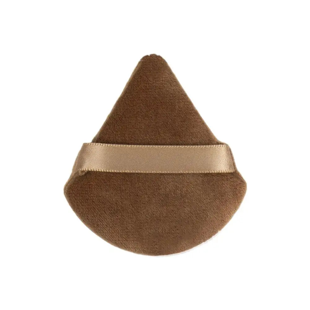 A triangular velvet powder puff in a brown color with a light beige band around the middle.