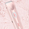 A pink double-head electric body shaver is shown against a light, watery background.