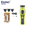 A yellow Kemei KM-999 cordless electric hair clipper with a black charging cable and blade attachments.