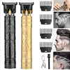 A set of vintage cordless hair cutting and trimming tools in black and gold finishes.