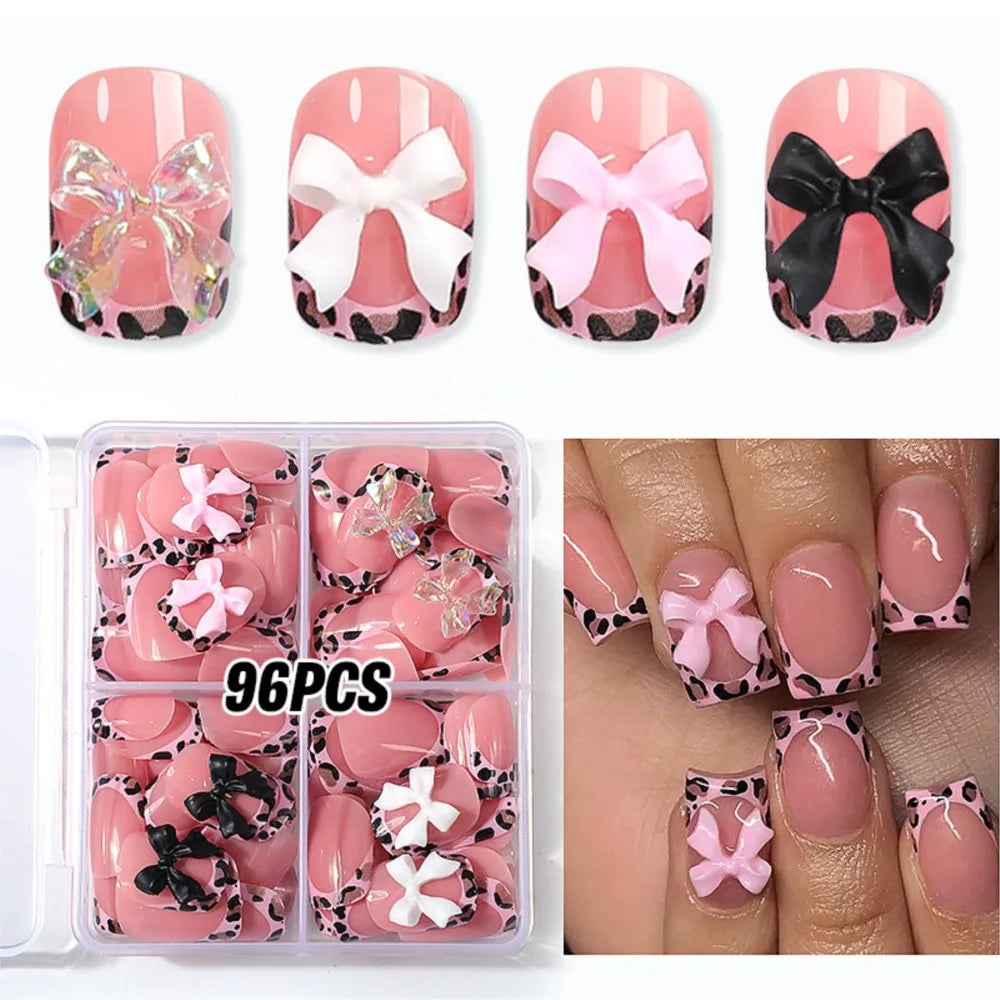 A set of 96 leopard print press-on nails in pink and white designs displayed on fingernails.
