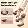 A set of delicate woolen yarn makeup brushes with natural brown and beige bristles shown in various angles.