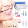 Una caja de hilo dental de silicona con hilos individuales junto a la boca de una persona para la higiene oral