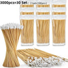 A collection of wooden cotton swabs and white cotton tips are displayed in various arrangements.